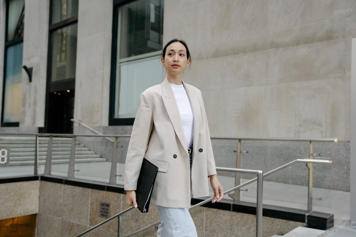 Businesswoman walking outside a modern office building